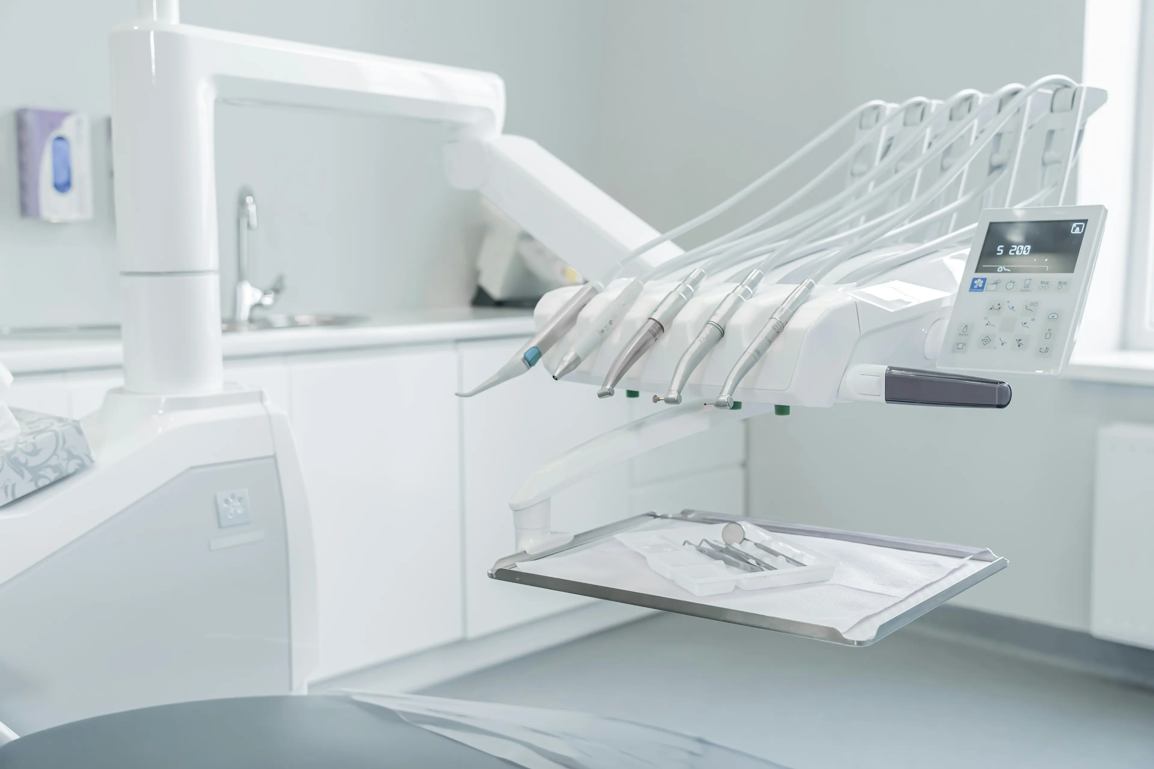 Clean, organized dental lab workspace with precision instruments and modern lighting